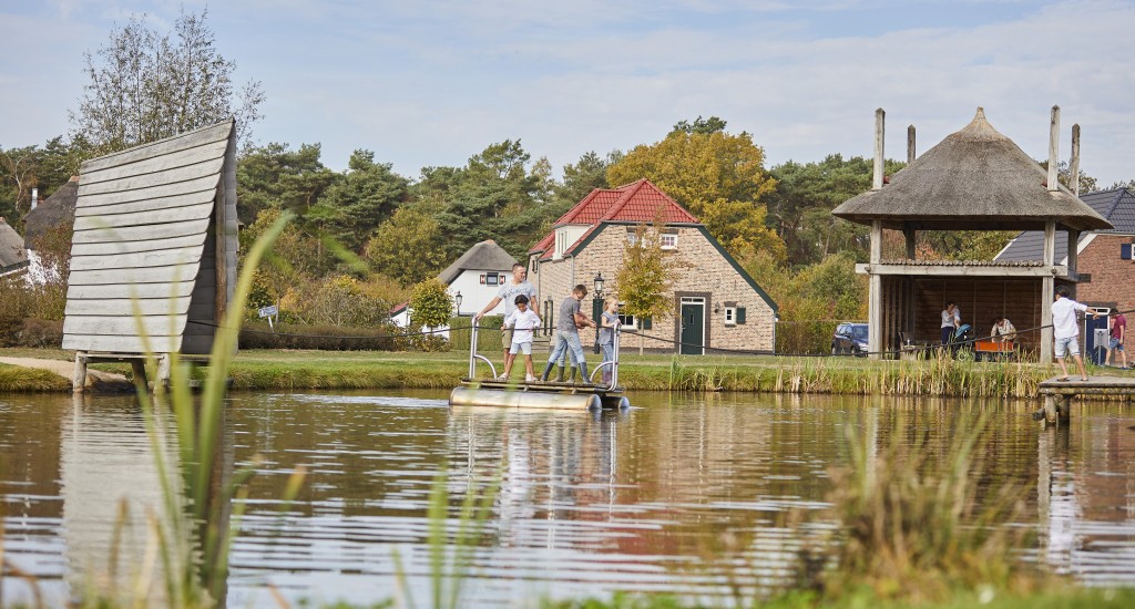 kinderen op een trekvlot op een vijver op Recreatiepark de Leistert in Limburg